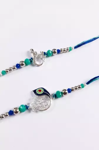 set of 2 silver toned beaded religious thread rakhi with roli chawal chandan mishri