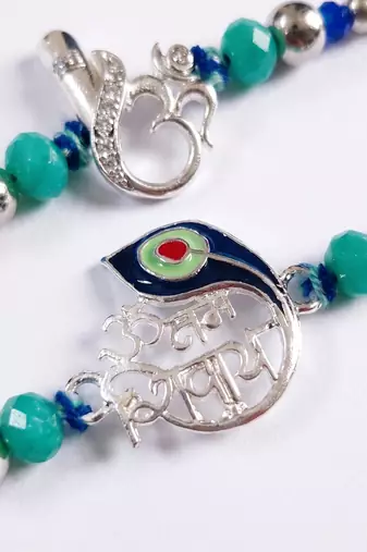 set of 2 silver toned beaded religious thread rakhi with roli chawal chandan mishri