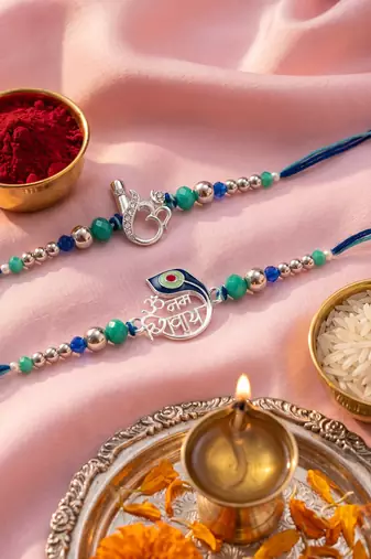 set of 2 silver toned beaded religious thread rakhi with roli chawal chandan mishri
