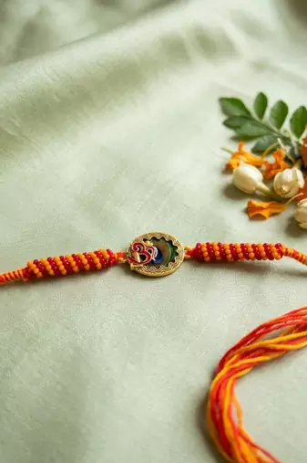 om motif divine religious thread rakhi with roli chawal chandan mishri