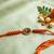 om motif divine religious thread rakhi with roli chawal chandan mishri