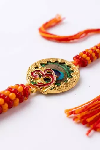 om motif divine religious thread rakhi with roli chawal chandan mishri