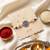 round artificial stones & beads brown thread rakhi with roli chawal chandan mishri