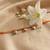 golden ghungroo thread rakhi with roli chawal chandan mishri