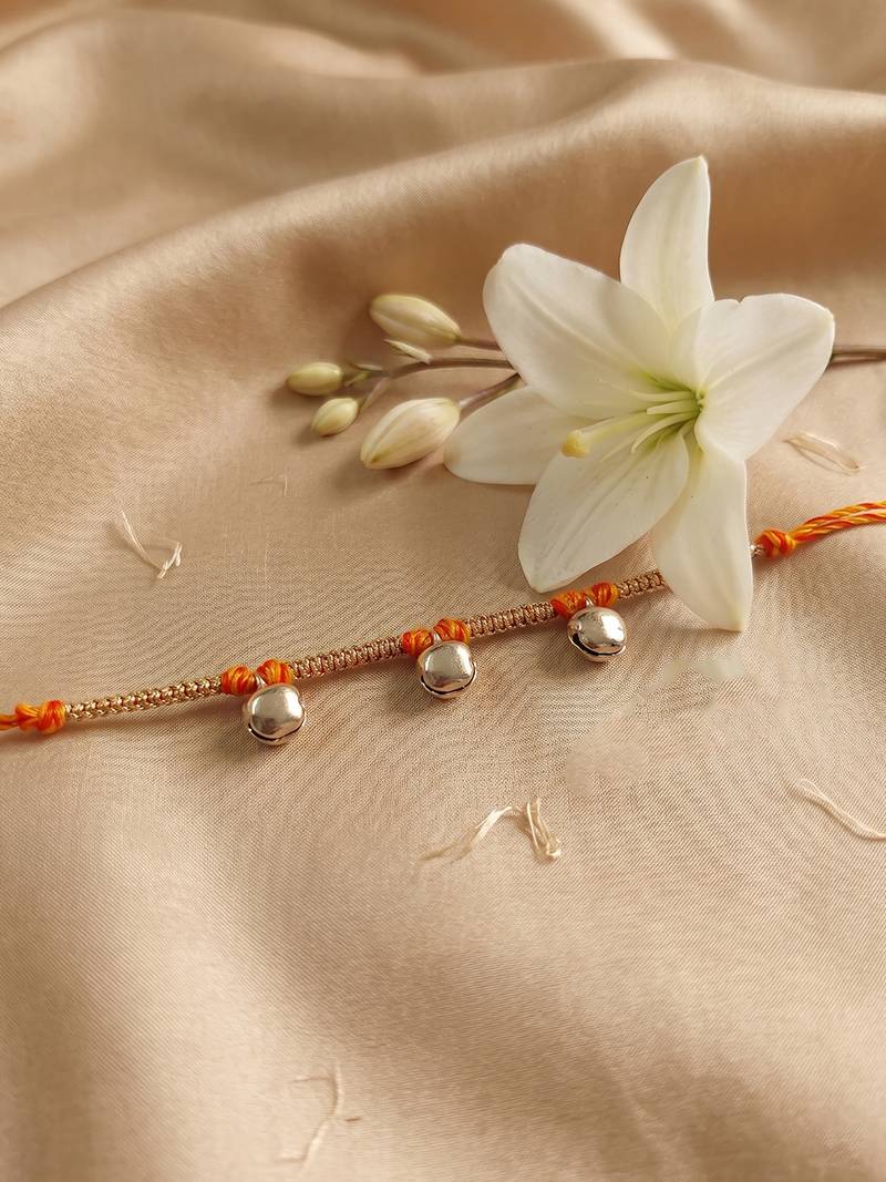 golden ghungroo thread rakhi with roli chawal chandan mishri