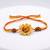 yellow floral seed thread rakhi with roli chawal chandan mishri