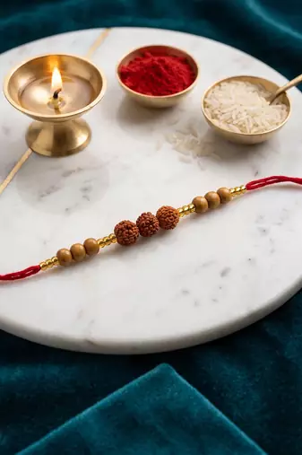 religious rudraksh & red thread rakhi with roli chawal chandan mishri