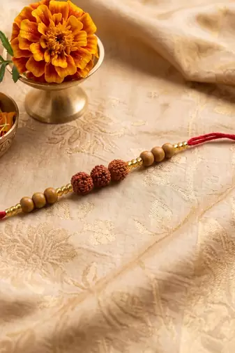 religious rudraksh & red thread rakhi with roli chawal chandan mishri