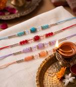 set of 4 multicolor artificial beads thread rakhi with roli chawal chandan mishri
