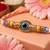 set of 4 multicolor evil eye thread rakhi with roli chawal chandan mishri