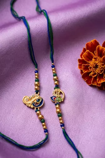 set of 2 krishna & peacock design artificial beads thread rakhi with roli chawal