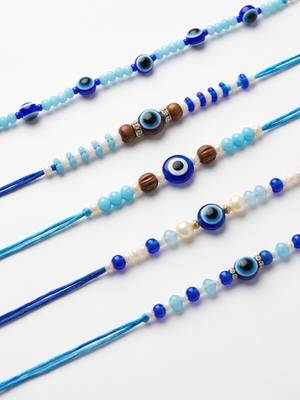 set of 5 blue evil eye thread rakhi with roli chawal chandan mishri 4