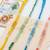 set of 4 multicolor artificial beads thread rakhi with roli chawal chandan mishri