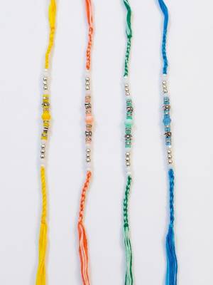 set of 4 multicolor artificial beads thread rakhi with roli chawal chandan mishri 2