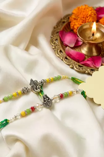 set of 2 multicolor religious thread rakhi with roli chawal chandan mishri