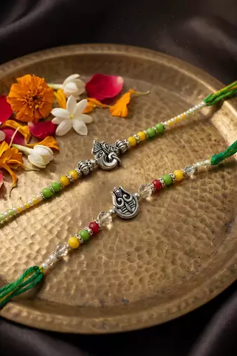 set of 2 multicolor religious thread rakhi with roli chawal chandan mishri