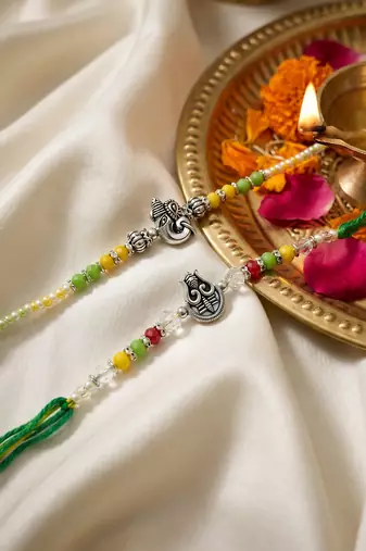 set of 2 multicolor religious thread rakhi with roli chawal chandan mishri