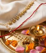 set of 2 pearls gold toned bhaiya bhabhi rakhi with roli chawal chandan mishri