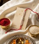 white pearls & red thread rakhi with roli chawal chandan mishri