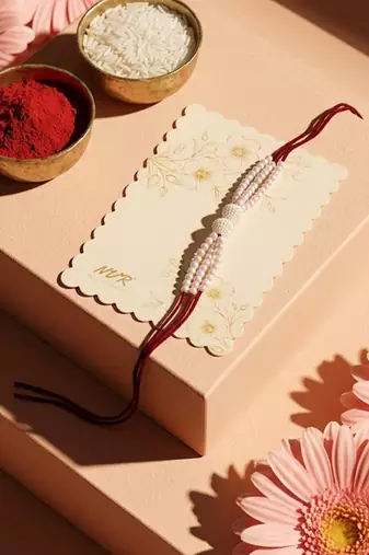 white pearls & red thread rakhi with roli chawal chandan mishri