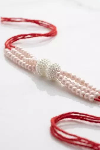 white pearls & red thread rakhi with roli chawal chandan mishri