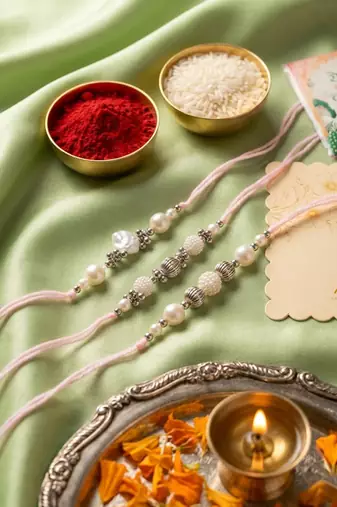 set of 3 white pearls thread rakhi with roli chawal chandan mishri