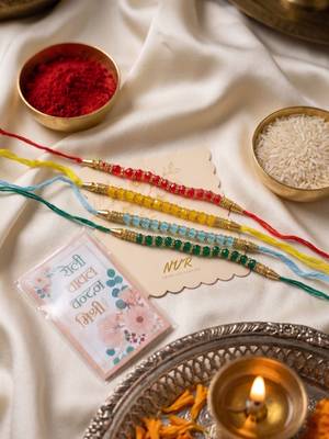 set of 4 multicolor artificial beads thread rakhi with roli chawal chandan mishri 1