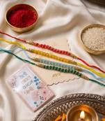 set of 4 multicolor artificial beads thread rakhi with roli chawal chandan mishri