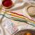 set of 4 multicolor artificial beads thread rakhi with roli chawal chandan mishri