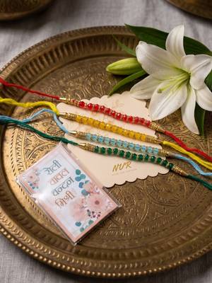 set of 4 multicolor artificial beads thread rakhi with roli chawal chandan mishri 3