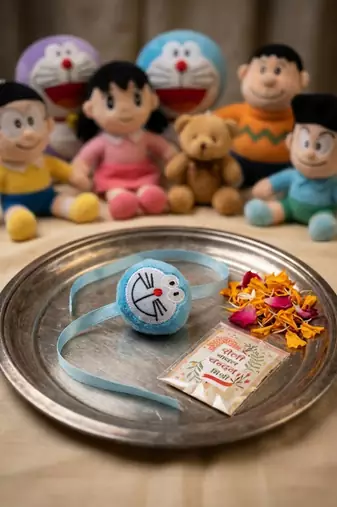 kids doremon design thread rakhi with roli chawal chandan mishri
