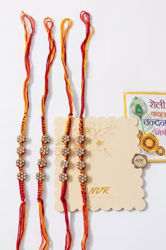 set of 4 artificial stones floral design thread rakhi with roli chawal chandan mishri