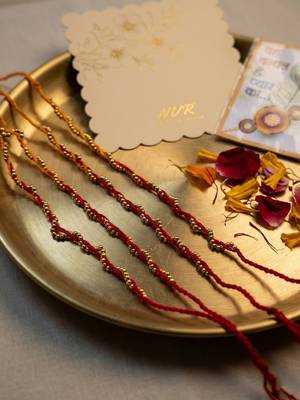 set of 4 red & yellow thread rakhi with roli chawal chandan mishri 4