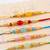 set of 5 multi artificial beads thread rakhi with roli chawal chandan mishri