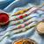 set of 5 multi artificial beads thread rakhi with roli chawal chandan mishri