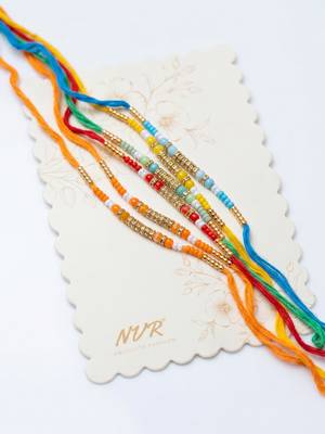 set of 6 multi artificial beads thread rakhi with roli chawal chandan mishri 1