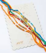 set of 6 multi artificial beads thread rakhi with roli chawal chandan mishri