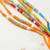 set of 6 multi artificial beads thread rakhi with roli chawal chandan mishri