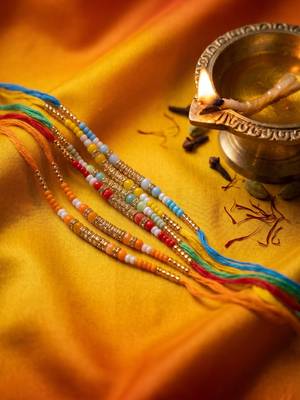 set of 6 multi artificial beads thread rakhi with roli chawal chandan mishri 3