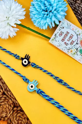 set of 2 evil eye & blue thread rakhi with roli chawal chandan mishri