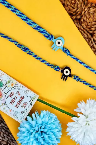 set of 2 evil eye & blue thread rakhi with roli chawal chandan mishri