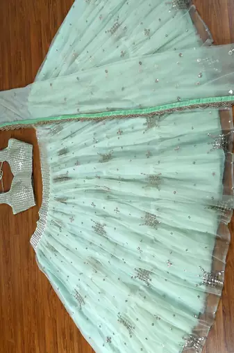 pista green net ruffle lehenga choli with embroidered dupatta