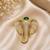 Elephant head designer brooch pin with green cabochon stone & luxury animal brooch for unisex