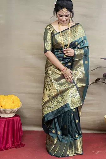 Deep teal green banarasi silk blend saree with golden zari work