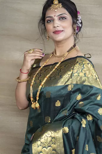Deep teal green banarasi silk blend saree with golden zari work