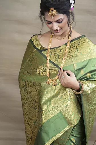 Green banarasi silk blend saree with golden zari work