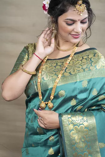 Turquoise banarasi silk blend saree with golden zari work