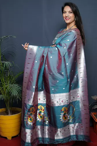 Teal blue paithani silk blend saree with silver zari border