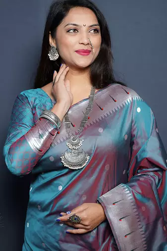 Teal blue paithani silk blend saree with silver zari border