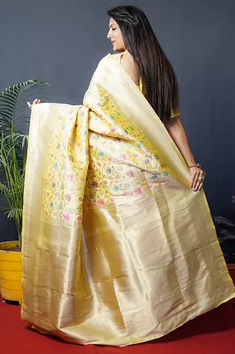 Lemon yellow banarasi silk blend saree with floral jaal & zari border